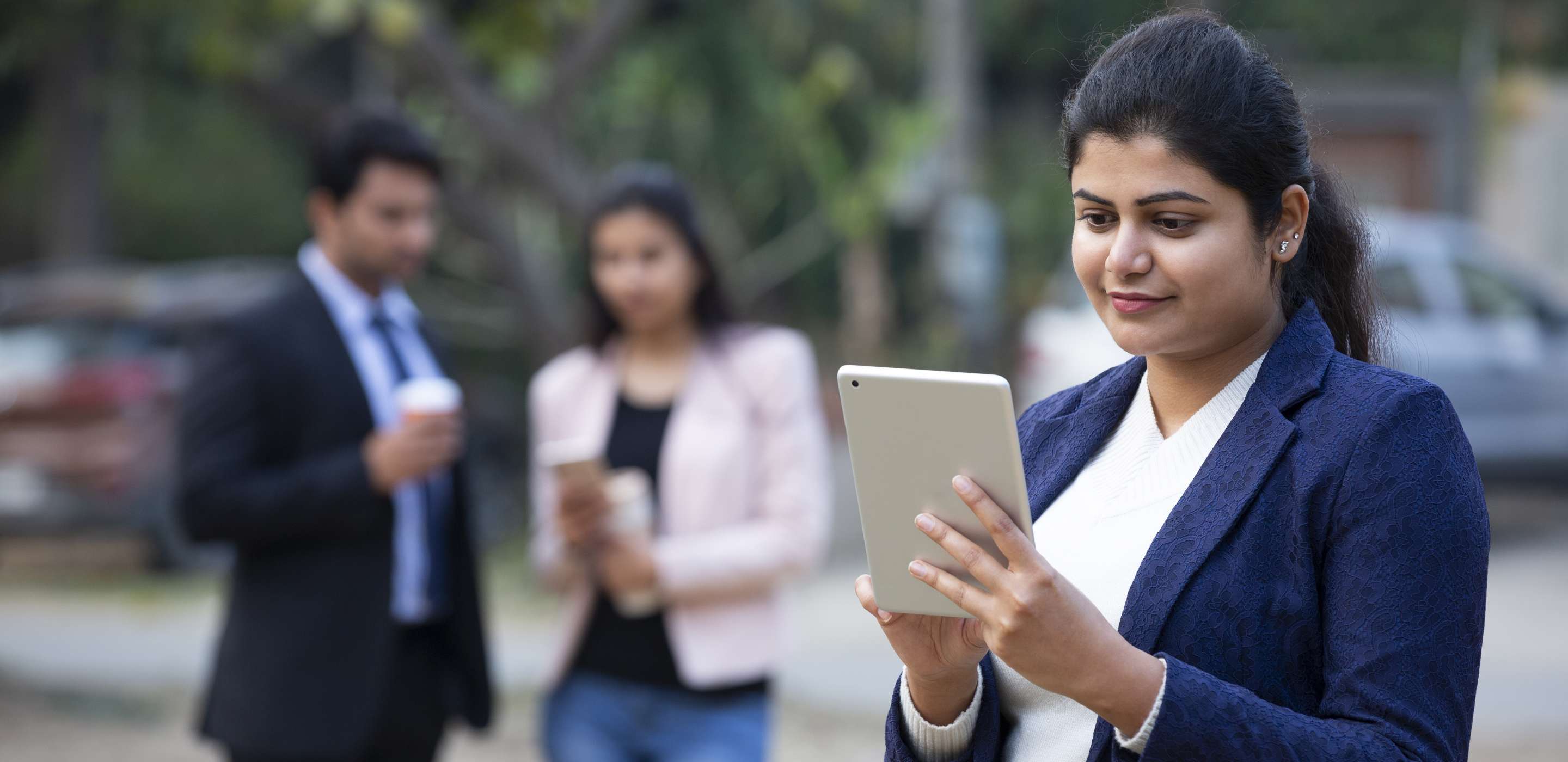 A lady looking at a tablet screen