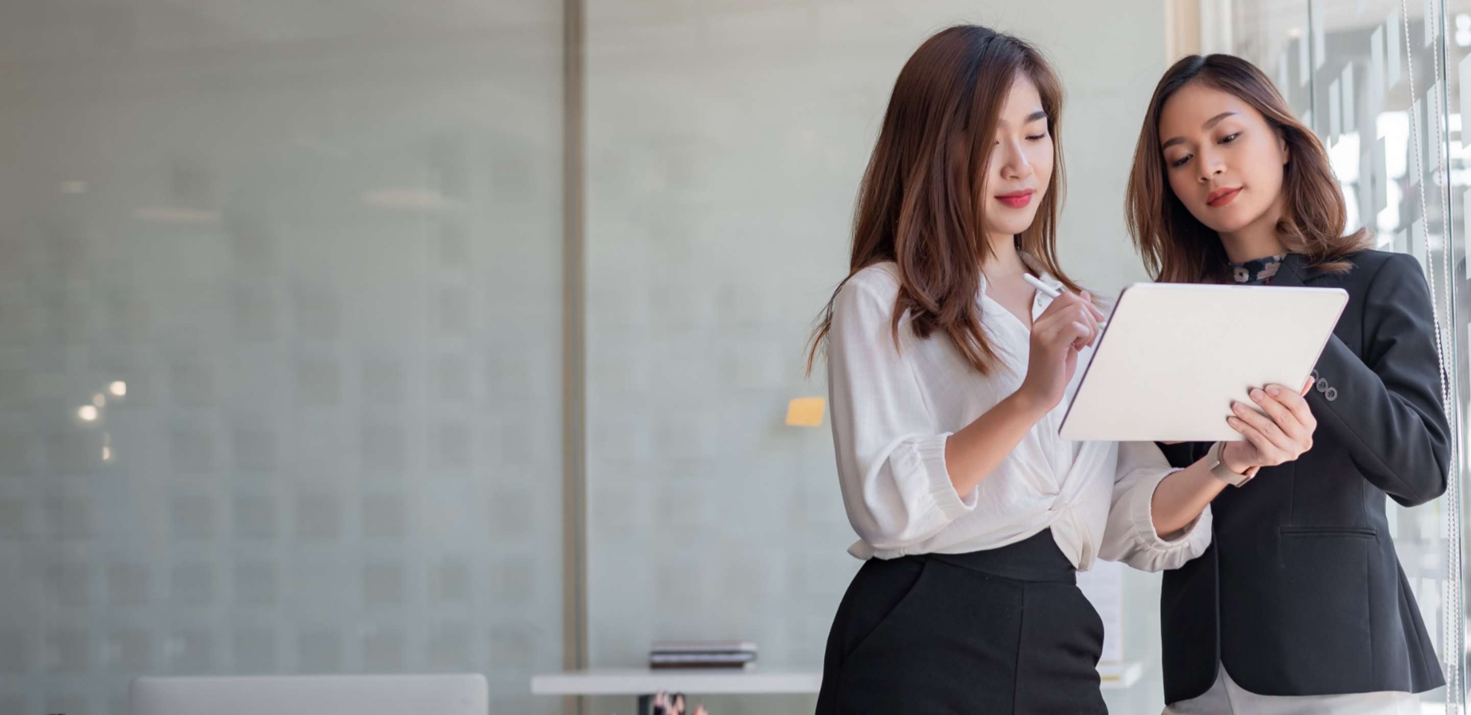 Two business professionals looking on a ipad