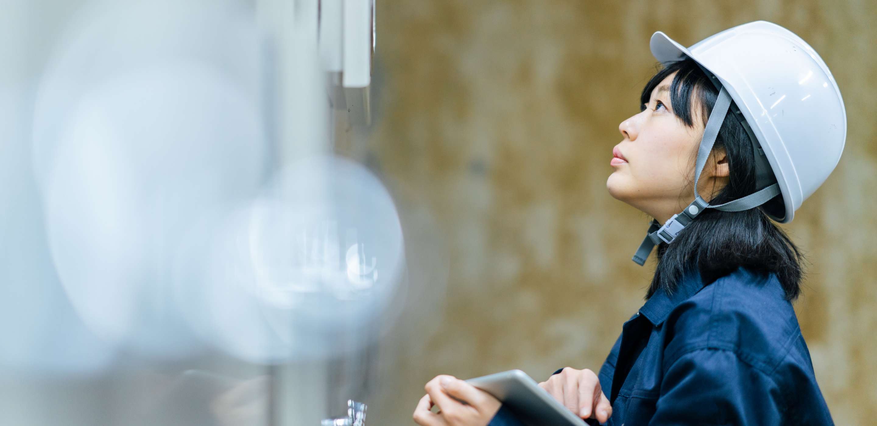 A woman wearing a helmet looking up