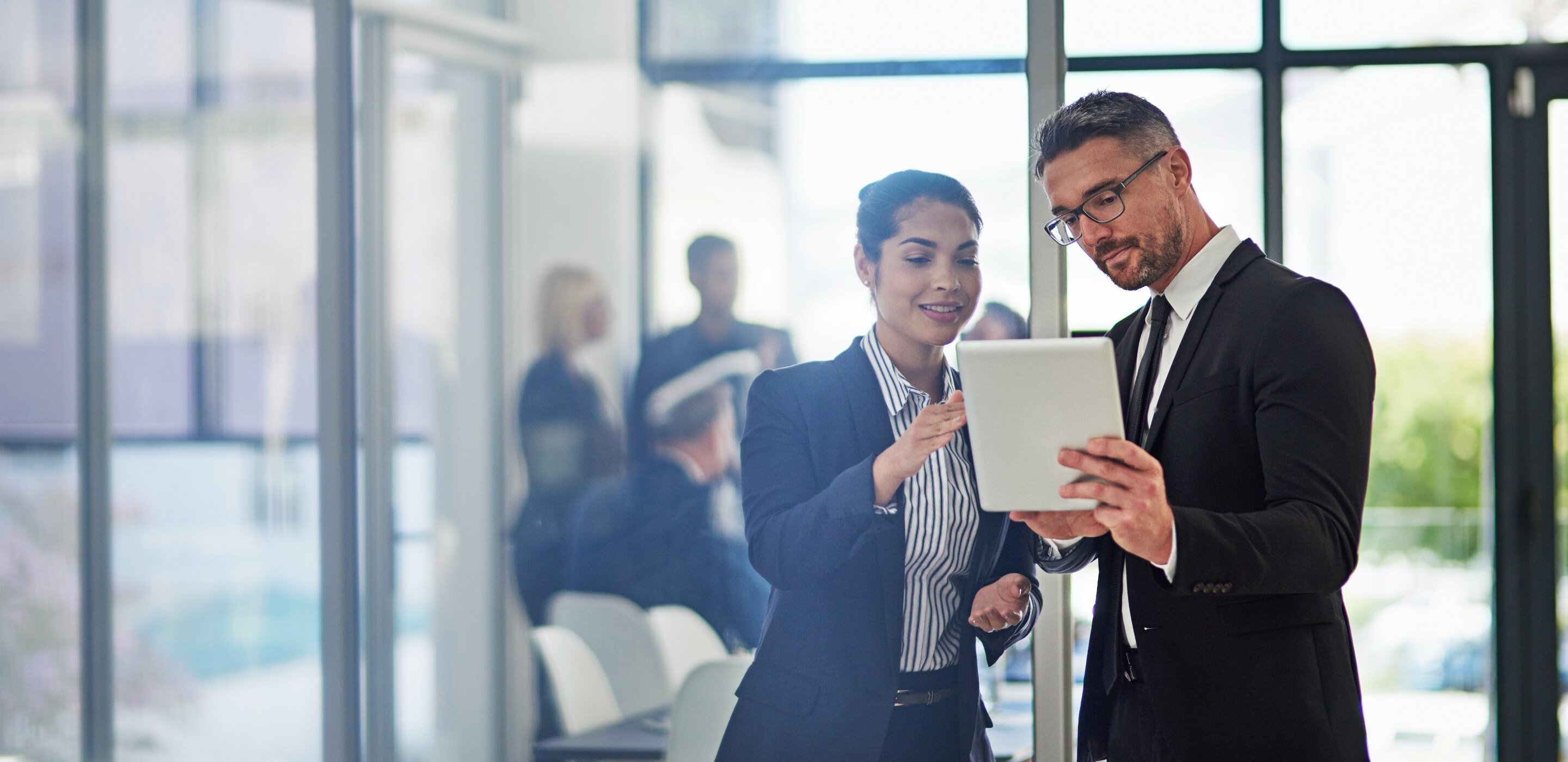 Business professionals pointing on the tablet