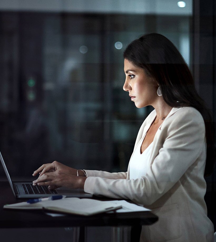 Shot of a young businesswoman using a laptop at work