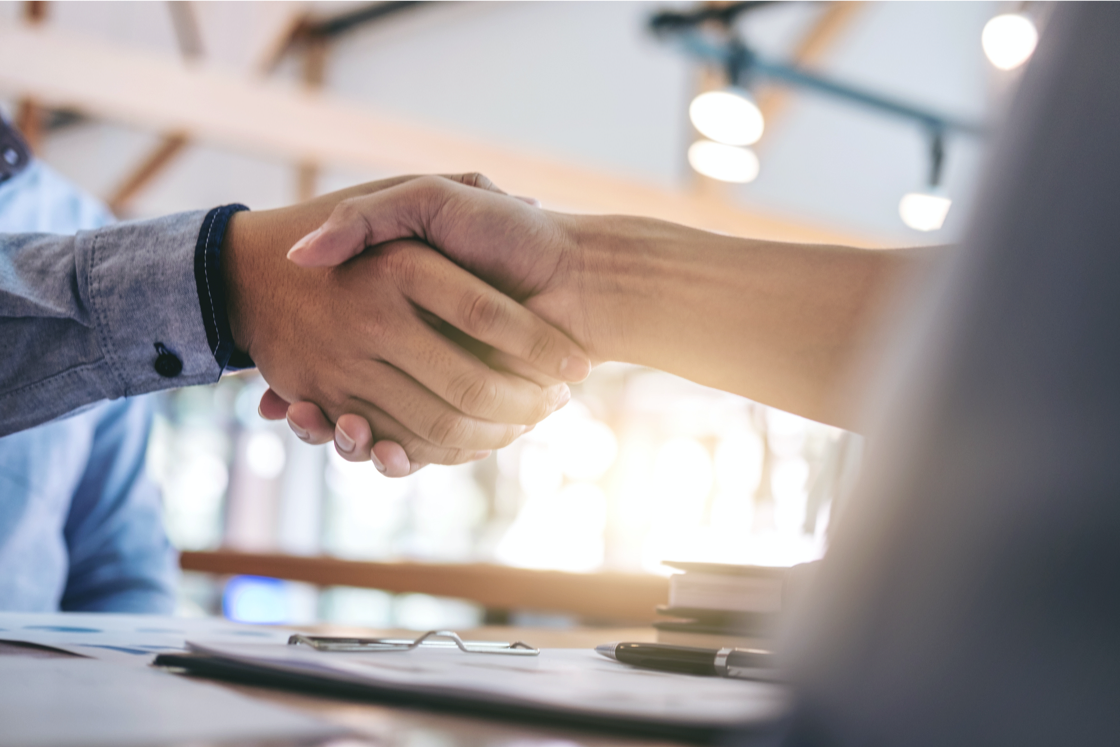 Handshake  on the background of light from a window