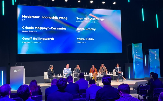 A panel on stage with big screen on top