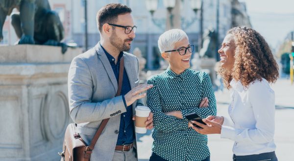 Three business people walking and talking