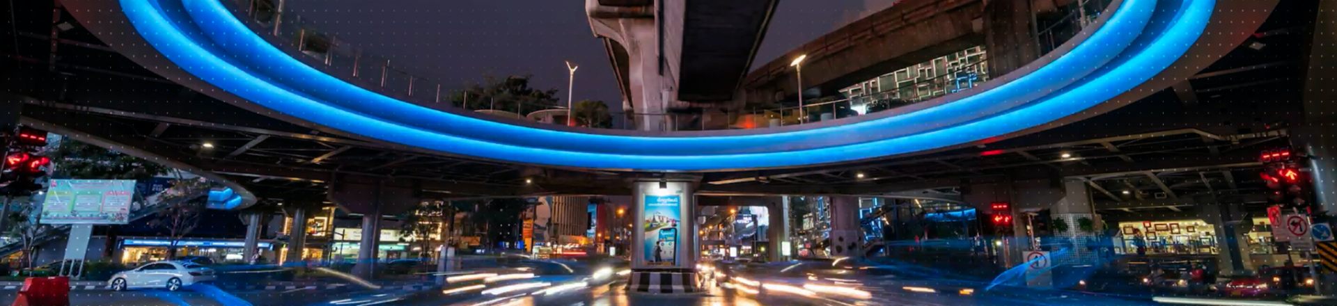 Street at night with a brightly lit arc overhead