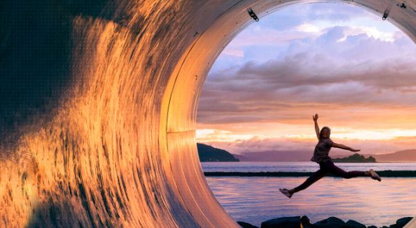 Woman leaping with water in the background