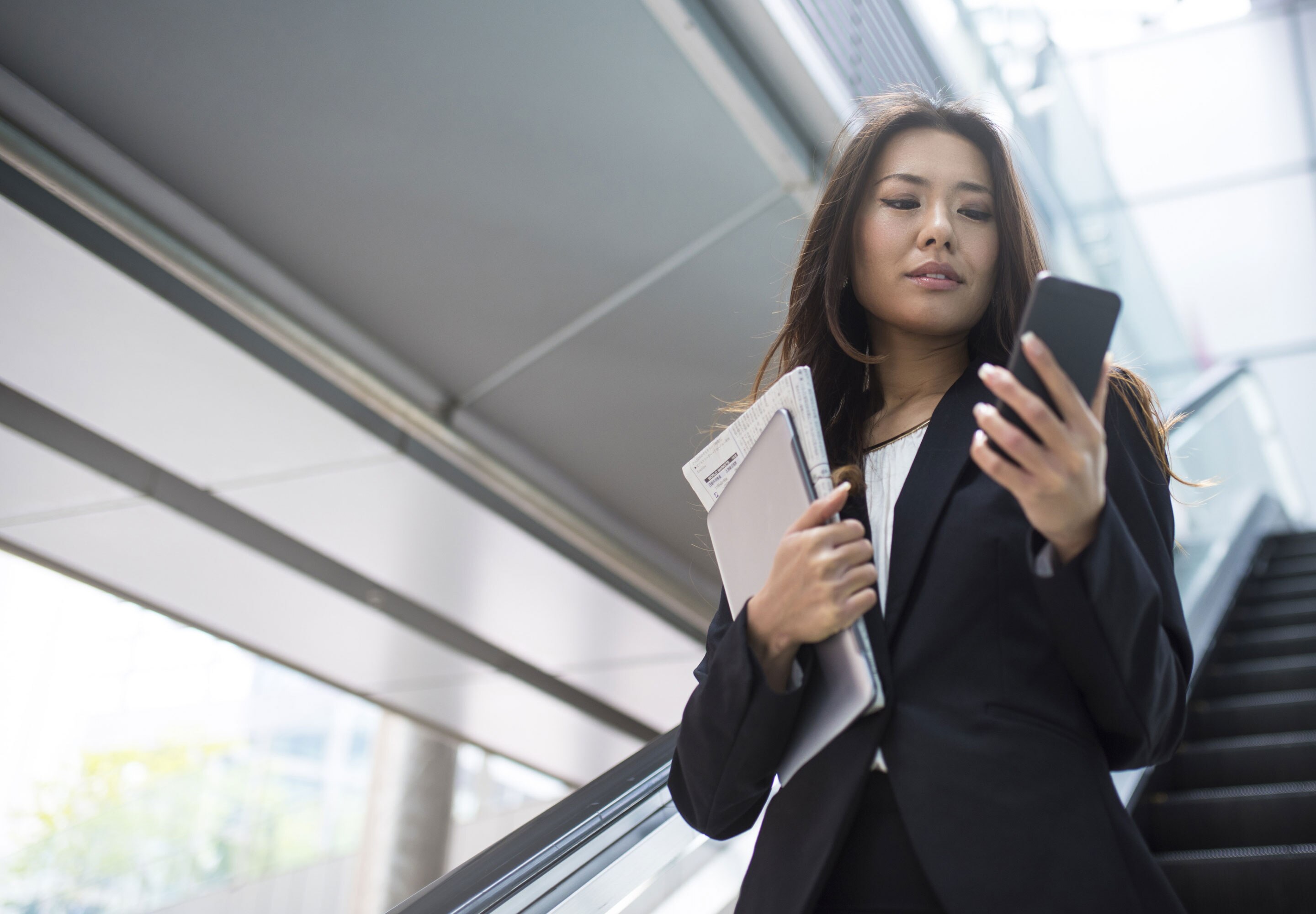 Business professional looking at her mobile phone