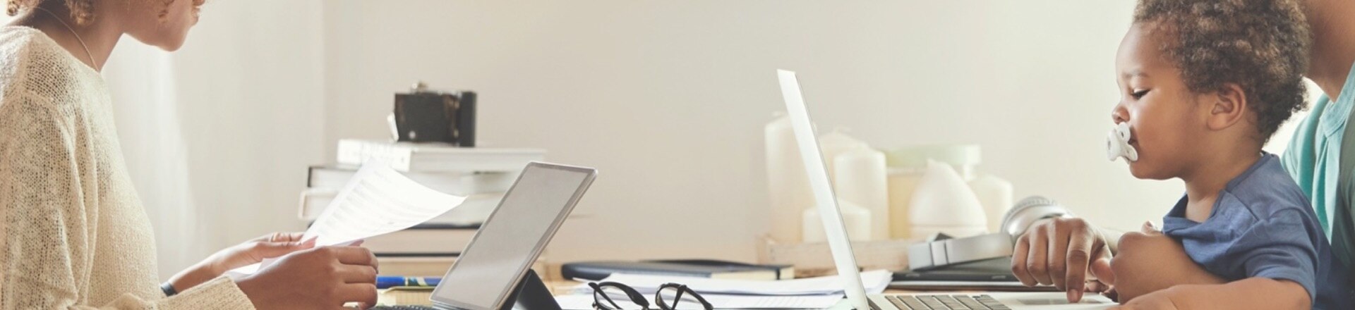 A couple working from home with a toddler on his lap
