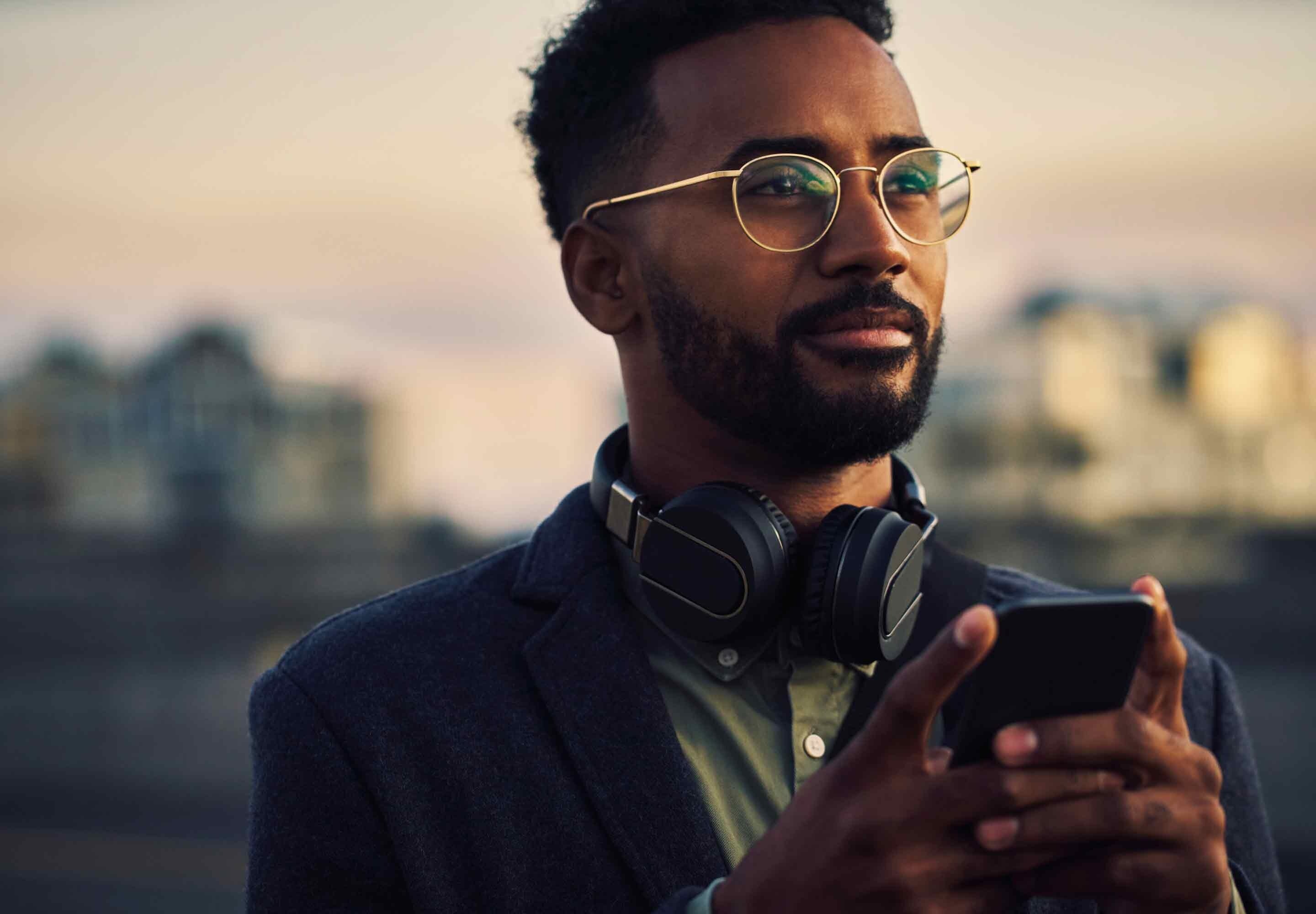 Man with a mobile phone looking into the distance