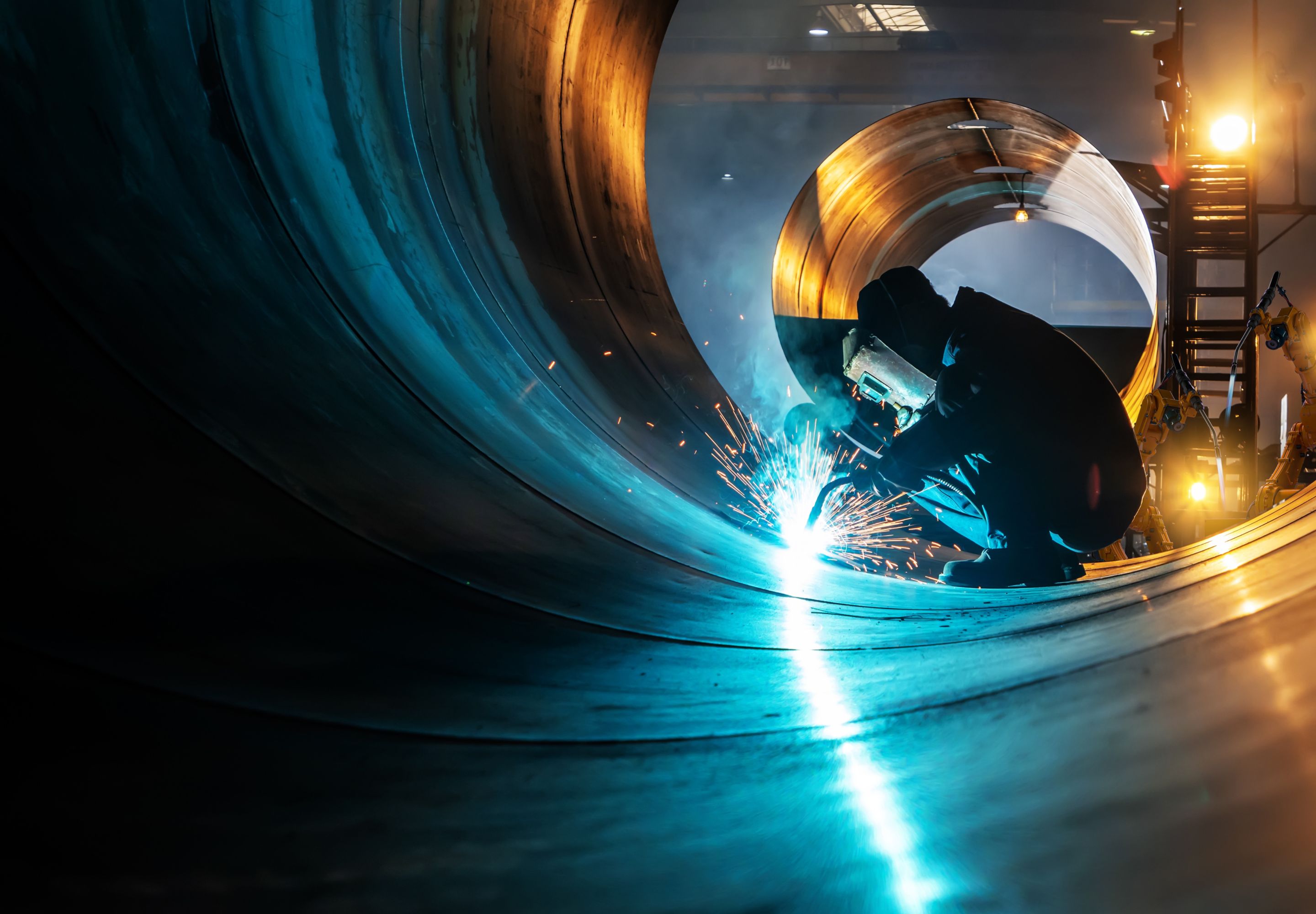 Welder welding in a large tube