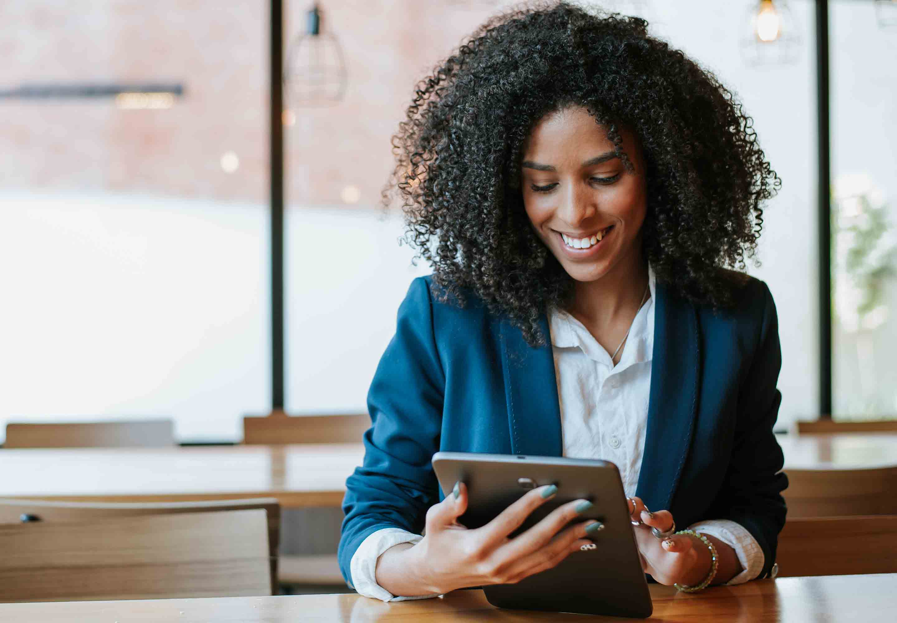 Lady in blue jacket holding a tablet