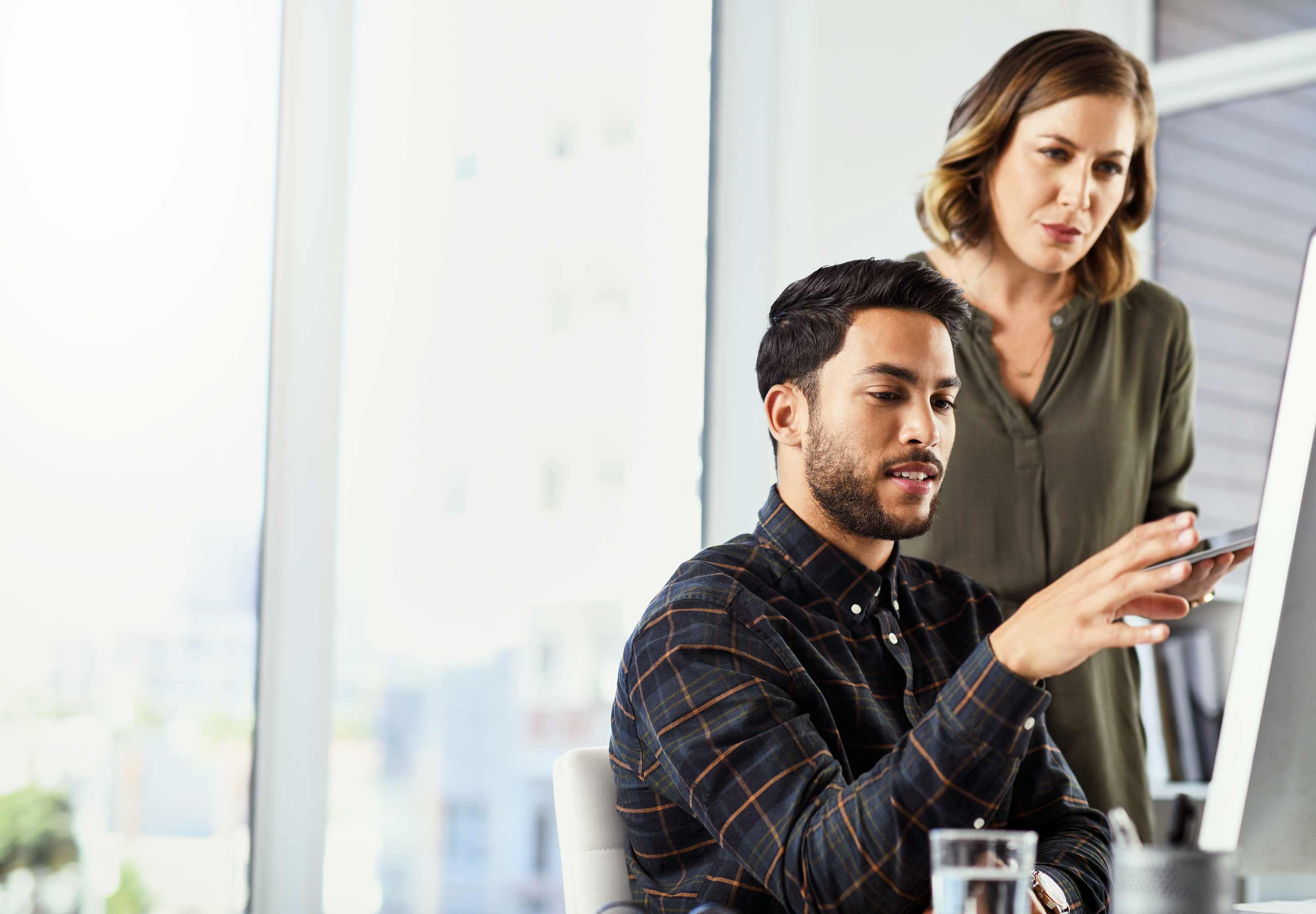 A man and a woman looking at a drawing board
