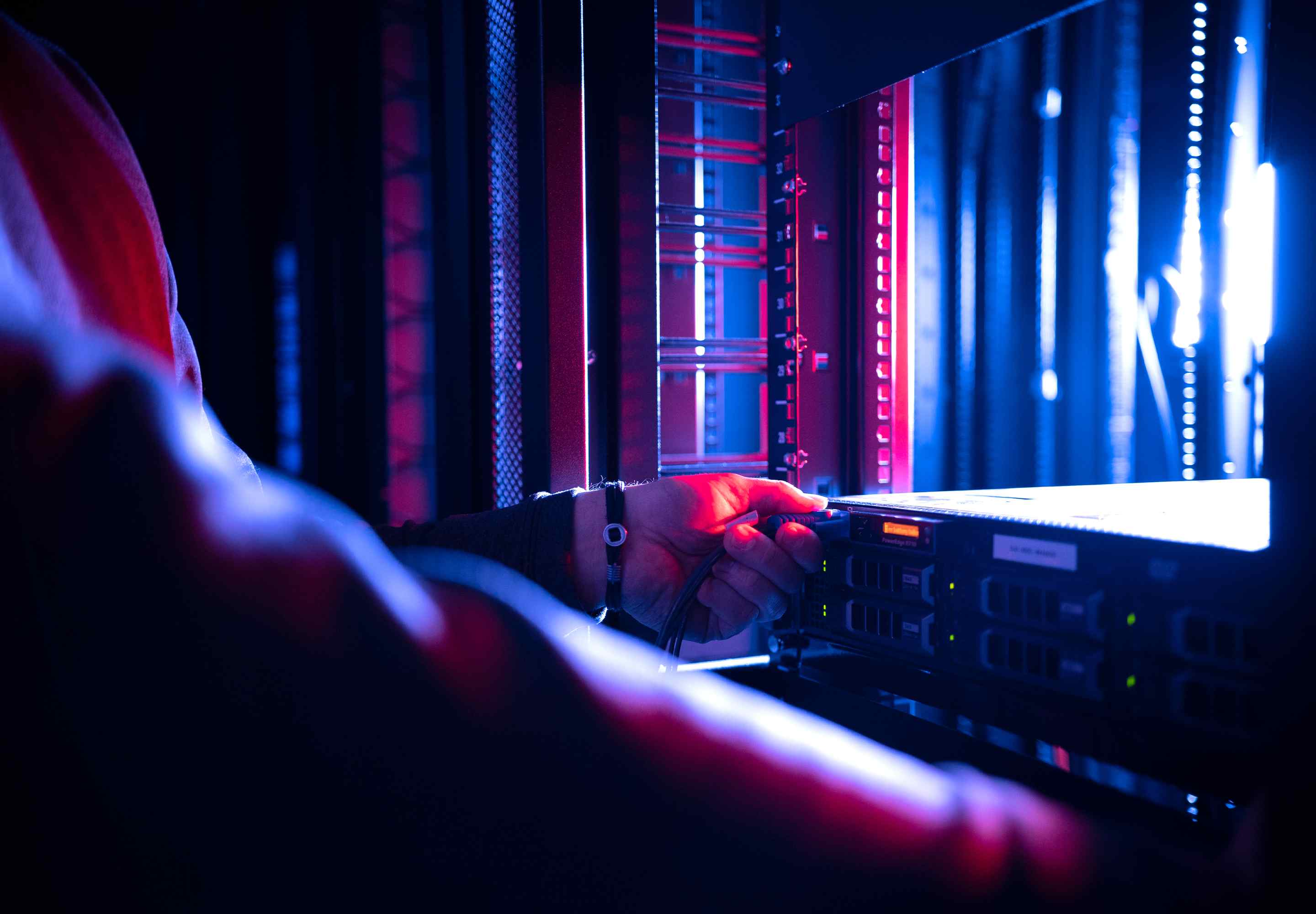 Tech installs a server into a rack