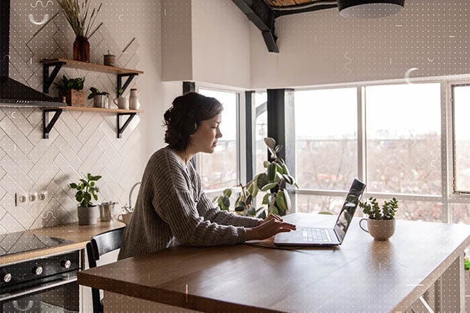 Woman working on her laptop at a counter