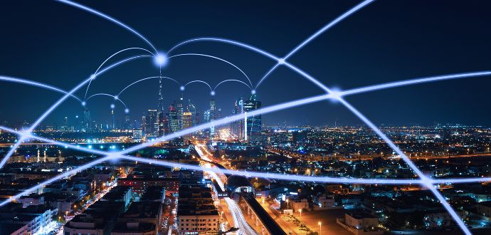 Light beams connecting city buildings at night