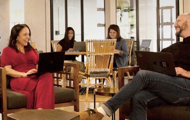 Colleagues sitting in an open plan lounge area
