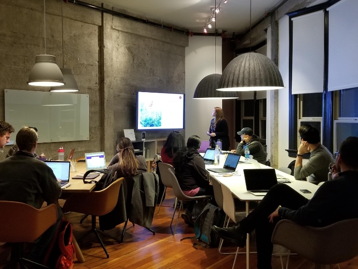 Teams working together in an open plan office to collaborate