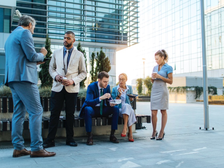 Colleagues sitting outside of a building